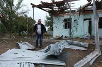 A man stands in a yard of a destroyed house damaged by shelling during fighting over the breakaway region of Nagorno-Karabakh in Agdam, Azerbaijan, Thursday, Oct. 1, 2020. Clashes broke out Sunday in Nagorno-Karabakh, a region within Azerbaijan that has been controlled by ethnic Armenian forces backed by the Armenian government since the end of a separatist war a quarter-century ago. Fighting has continued unchecked since then, killing dozens and leaving scores wounded. Armenian and Azerbaijani forces blame each other for continuing attacks. (AP Photo/Aziz Karimov)