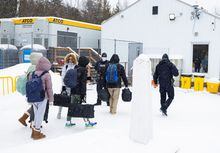 Asylum seekers cross into Canada from the U.S. border on Roxham Road in Champlain, New York, U.S., February 25, 2023. REUTERS/Christinne Muschi