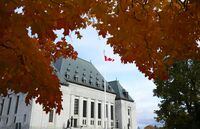 The Supreme Court of Canada is pictured under fall coloured leaves in Ottawa, on Thursday, Oct. 20, 2022.&nbsp;The Supreme Court of Canada will look at whether a law banning publication of certain proceedings in criminal matters applies before the selection of a jury. THE CANADIAN PRESS/Sean Kilpatrick