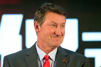 FILE - Former NHL hockey player Wayne Gretzky smiles during a promotional event for the Beijing Kunlun Red Star hockey team in Beijing, in this Thursday, Sept. 13, 2018, file photo. Alex Ovechkin starts a new five-year contract ready to chase Gretzky's career goals record that long seemed unbreakable. The Washington Capitals captain has 730 goals and needs 165 to pass Gretzky.  (AP Photo/Mark Schiefelbein, File)