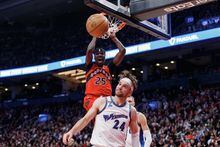 Toronto Raptors forward Chris Boucher (25) reacts as he dunks against Washington Wizards forward Corey Kispert (24) during the second half of their NBA game in Toronto on Sunday, Mar. 26, 2023. THE CANADIAN PRESS/Cole Burston