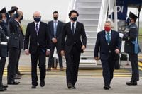 Canada's Prime Minister Justin Trudeau (C), wearing a face covering due to Covid-19, waves after landing at Cornwall Airport Newquay, near Newquay, Cornwall, on June 10, 2021, ahead of the three-day G7 summit being held from 11-13 June. (Photo by Alberto Pezzali / POOL / AFP) (Photo by ALBERTO PEZZALI/POOL/AFP via Getty Images)