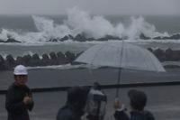 Waves hit ashore as Tropical Storm Meari is moving over coastal waters, in Shizuoka, southwest of Tokyo Saturday, Aug. 13, 2022. Shizuoka Prefecture was told to brace for extremely heavy rainfall. (Kyodo News via AP)