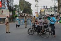 Police personnel inspect people along a street during a government-imposed nationwide lockdown as a preventive measure against the COVID-19 coronavirus, in Siliguri, India on April 3, 2020.
