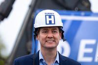 B.C. Premier David Eby wears a hard hat with a hospital sign affixed during an announcement for a new hospital in Surrey B.C. on Tuesday, September 12, 2023. THE CANADIAN PRESS/Ethan Cairns 