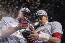 Kansas City Chiefs tight end Travis Kelce, left, and teammate quarterback Patrick Mahomes celebrate after the NFL AFC Championship playoff football game against the Cincinnati Bengals, Sunday, Jan. 29, 2023, in Kansas City, Mo. The Chiefs won 23-20. (AP Photo/Charlie Riedel)
