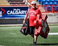 Calgary Stampeders' trainer George Hopkins, who is in his 51st year with the CFL team carries equipment in Calgary, Monday, July 11, 2022.THE CANADIAN PRESS/Jeff McIntosh