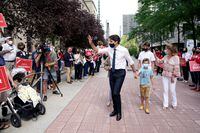 Liberal Party Leader Justin Trudeau greets a crowd of supporters with his family in tow after triggering a federal election, in Ottawa, Sunday, Aug. 15, 2021. New survey results suggest Justin Trudeau's Liberals were clinging to a five-point lead on the eve of the federal election campaign. THE CANADIAN PRESS/Sean Kilpatrick