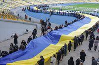 Public servants carry the biggest Ukrainian fliag toi mark Unity day announced by president Zelensky earlier in Kyiv Ukraine  Feb 16, 2022.