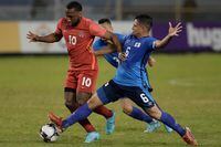 Canada's David Junior Hoilett, left, fights for the ball with El Salvador's Narciso Orellana during a qualifying soccer match for the FIFA World Cup Qatar 2022 at Cuscatlan stadium in San Salvador, El Salvador, Wednesday, Feb. 2, 2022. (AP Photo/Moises Castillo)
