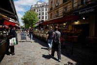 FILE PHOTO: People walk past food shops on a street in Paris, France, June 10, 2022. REUTERS/Sarah Meyssonnier