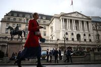 People stand outside the Bank of England in the City of London financial in London, Britain, Oct. 3.