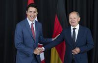 Prime Minister Justin Trudeau greets German Chancellor Olaf Scholz in Montreal on Monday, August 22, 2022. The federal government is poised to sign agreements to work with Volkswagen and Mercedes-Benz on supplying raw materials for batteries in electric vehicles.THE CANADIAN PRESS/Paul Chiasson