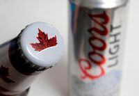 Photo products from the Mondelez International family of brands, Molson beer, left, and Coors Light beer rest together, in Walpole, Mass., on Nov. 28, 2017. THE CANADIAN PRESS/AP, Steven Senne