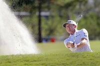 Mackenzie Hughes hits out of a bunker on the 10th green during the second round of the Houston Open golf tournament Friday, Nov. 11, 2022, in Houston. (AP Photo/Michael Wyke)