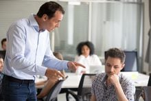 Angry boss scolding frustrated incompetent employee at workplace, dissatisfied leader shouting, pointing finger at bad office worker for bad work, laziness, sad man getting reprimand, job loss concept