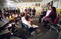 9/11 Kids (Documentary).  President George W. Bush with the Grade 2 Class of Booker Elementary School on September 11, 2001. It’s one of the most memorable moments from 9/11: White House Chief of Staff Andy Card walks up to President George W. Bush and whispers in his ear: “A second plane has hit the second tower. America is under attack.” The place was Emma E. Booker Elementary School in Sarasota, Florida. Sitting in front of the President were sixteen school children, all 6-7 years old. What happened to those kids? Which ones went on to graduate college and get a good job? Who fell on hard times and why? We’ve tracked them down to find out what they remember, what’s happened since, and their dreams for the future. Courtesy of CBC Gem