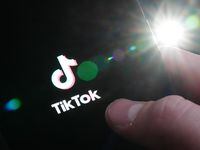The TikTok startup page is displayed on an iPhone in Ottawa on Monday, Feb. 27, 2023. Ontario says it is banning the social media app TikTok on government-owned devices.THE CANADIAN PRESS/Sean Kilpatrick