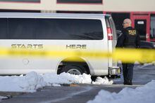 A law enforcement officer walks outside the Starts Right Here building, Monday, Jan. 23, 2023, in Des Moines, Iowa. Police say two students were killed and a teacher was injured in a shooting at the Des Moines school on the edge of the city's downtown. (AP Photo/Charlie Neibergall)
