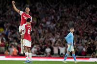 Manchester City's Phil Foden, right, watches Arsenal's William Saliba, top, and Arsenal's Gabriel celebrate winning the English Premier League soccer match between Arsenal and Manchester City at the Emirates Stadium in London, Sunday, Oct. 8, 2023.(AP Photo/Kirsty Wigglesworth)