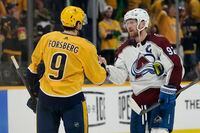 Colorado Avalanche left wing Gabriel Landeskog (92) shakes hands with Nashville Predators' Filip Forsberg (9) after Game 4 of an NHL hockey first-round playoff series Monday, May 9, 2022, in Nashville, Tenn. The Avalanche won 5-3 to sweep the series 4-0. (AP Photo/Mark Humphrey)