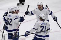 Tampa Bay Lightning defenseman Cal Foote (52) celebrates with Nikita Kucherov, left, Brayden Point (21), and Anthony Cirelli (71), after scoring a goal against the Chicago Blackhawks during the second period of an NHL hockey game, Sunday, March 6, 2022, in Chicago. (AP Photo/Matt Marton)