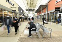 People shop at the Toronto Premium Outlets mall in Milton, Ont., Friday, Nov. 27, 2020. As many Canadians no longer fear congregating and vaccine passports have been dropped, real estate firms say retail and restaurant chains are scrambling to pick up space again. THE CANADIAN PRESS/Nathan Denette