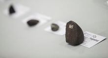 Scientists from Western University and NASA display some meteorites during a press conference in St.Thomas, Ont., Friday, March 21, 2014. On April 8, a fireball ripped through the Earth's atmosphere and landed somewhere in New Brunswick, prompting Maine Mineral and Gem Museum in Bethel to offer a US$25,000 reward for the first one kilogram meteorite recovered. THE CANADIAN PRESS/ Geoff Robins