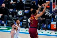 Cleveland Cavaliers forward Lamar Stevens (8) dunks in front of Oklahoma City Thunder guard Ty Jerome, left, and center Tony Bradley during the second half of an NBA basketball game Thursday, April 8, 2021, in Oklahoma City. (AP Photo/Sue Ogrocki)