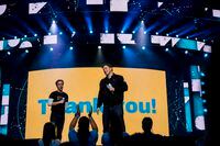 Craig and Marc Kielburger address the audience during a WE Day event in Toronto on Sept. 20, 2018.