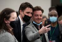 Canadian Prime Minister Justin Trudeau takes a selfie with a supporter as he arrives at the National Culture Summit, in Ottawa, Monday, May 2, 2022. THE CANADIAN PRESS/Adrian Wyld