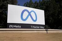 FILE - Facebook unveiled their new Meta sign at the company headquarters in Menlo Park, Calif., on, Oct. 28, 2021. Meta, formerly known as Facebook, and ridesharing company Lyft separately announced Tuesday, Dec. 7, 2021, that they're letting workers delay their return when offices fully reopen early next year. (AP Photo/Tony Avelar, File)