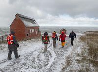 Members of a ground search and rescue team walk along the shore of the Bay of Fundy in Hillsburn, N.S. as they look for five fishermen missing after the scallop dragger Chief William Saulis sank in the Bay of Fundy, on Wednesday, Dec. 16, 2020. As Canadian fishers continue to die in frigid waters when their boats capsize, a debate is surfacing over why clear rules aren’t in place to ensure basic stability of vessels that face ocean storms.THE CANADIAN PRESS/Andrew Vaughan