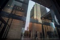 The financial district is reflected on the window as business people walk in Toronto on Wednesday, June 27, 2018.  Canadian venture capital funding recovered in the second quarter of the year following a substantial decline in the first three months of 2023, but is still 62 per cent lower year-to-date compared to 2022.THE CANADIAN PRESS/ Tijana Martin