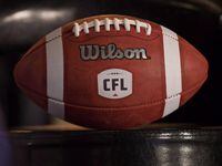 A football with the new CFL logo sits on a chair during a press conference in Winnipeg, Friday, November 27, 2015. The CFL is allowing its teams to reopen their fitness facilities during the COVID-19 pandemic. THE CANADIAN PRESS/John Woods