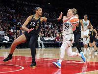 LAS VEGAS, NEVADA - OCTOBER 11: Courtney Vandersloot #22 of the New York Liberty drives against A'ja Wilson #22 of the Las Vegas Aces in the third quarter of Game Two of the 2023 WNBA Playoffs finals at Michelob ULTRA Arena on October 11, 2023 in Las Vegas, Nevada. The Aces defeated the Liberty 104-76. NOTE TO USER: User expressly acknowledges and agrees that, by downloading and or using this photograph, User is consenting to the terms and conditions of the Getty Images License Agreement. (Photo by Ethan Miller/Getty Images)