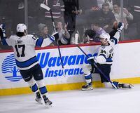 Winnipeg Jets’ Josh Morrissey (44) celebrates his game-winning goal against the Carolina Hurricanes with Adam Lowry (17) during overtime in NHL action in Winnipeg, Monday, Nov. 21, 2022. THE CANADIAN PRESS/Fred Greenslade