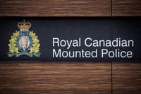The RCMP logo is seen outside Royal Canadian Mounted Police "E" Division Headquarters, in Surrey, B.C., on Friday, April 13, 2018. RCMP in Alberta say a 19-year-old female pedestrian died after she was hit by a Canadian Pacific Railway train in Banff. THE CANADIAN PRESS/Darryl Dyck