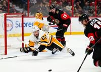 Pittsburgh Penguins defenceman Mark Friedman (52) dives in front of the net as Ottawa Senators left wing Tim Stützle (18) attempts a shot during second period NHL hockey action in Ottawa on Wednesday, Jan. 18, 2023. THE CANADIAN PRESS/Sean Kilpatrick