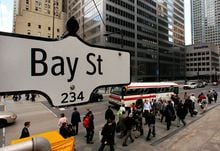 The Bay Street sign is pictured in the heart of the financial district as people walk by in Toronto, May 22, 2008.