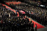 The casket of South Simcoe Police Service constable Morgan Russell is carried into a joint funeral service in Barrie, Ont., Thursday, Oct. 20, 2022. Russell and fellow SSPS constable Devon Northrup were killed in a shooting in Innisfil, Ont., last week. THE CANADIAN PRESS/Nathan Denette