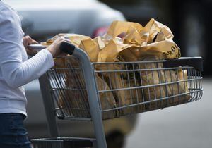 A women leaves a grocery store in Mississauga, Ont., on Thursday, August 15, 2019. A new working draft of the grocery code lays out the fundamental elements of the industry-led accord, which aims to increase "fair and ethical dealing" across the grocery supply chain in Canada.THE CANADIAN PRESS/Nathan Denette