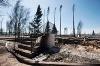 A set of steps is all that remains of a house in Slave Lake, Alta., on Monday, May 16, 2011. THE CANADIAN PRESS/Ian Jackson