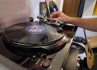 Dean Reid, founder of Canada Boy Vinyl, the only vinyl record factory in Canada, plays a record at the facility in Calgary, Alta., Thursday, Oct. 22, 2015. THE CANADIAN PRESS/Jeff McIntosh