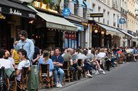 People eat and have drinks at a cafe terrace in the rue de Buci in Paris on June 2, 2020, as cafes and restaurants reopen in France with the easing of lockdown mesures taken to curb the spread of the COVID-19 pandemic, caused by the novel coronavirus. - French cafes and restaurants reopened their doors on June 2 as the country took its latest step out of coronavirus lockdown, with clients seizing the chance to bask on sunny terraces after 10 weeks of closures to fight the outbreak. (Photo by BERTRAND GUAY / AFP) (Photo by BERTRAND GUAY/AFP via Getty Images)