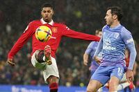 Manchester United's Marcus Rashford, left, challenges for the ball with Bournemouth's Adam Smith during the English Premier League soccer match between Manchester United and Bournemouth at Old Trafford in Manchester, England, Tuesday, Jan. 3, 2023. (AP Photo/Dave Thompson)