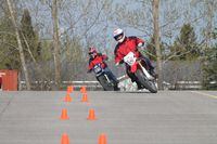 Students ride Fleming College's motorcycles through cones as part of an M2 training course in 2019.
