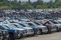 Vehicles are seen in a parking lot at the General Motors Oshawa Assembly Plant in Oshawa, Ont., on Wednesday, June 20, 2018. Statistics Canada says the country's merchandise trade surplus fell to $1.5 billion in April as both imports and exports hit record highs, helped by higher by rising prices. THE CANADIAN PRESS/ Tijana Martin