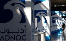 FILE PHOTO: Logos of ADNOC are seen at Gastech, the world's biggest expo for the gas industry, in Chiba, Japan, April 4, 2017.    REUTERS/Toru Hanai