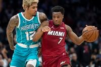 Miami Heat guard Kyle Lowry (7) attempts to drive past Charlotte Hornets guard Kelly Oubre Jr. (12) during the second half of an NBA basketball game Thursday, Feb. 17, 2022, in Charlotte, N.C. (AP Photo/Matt Kelley)
